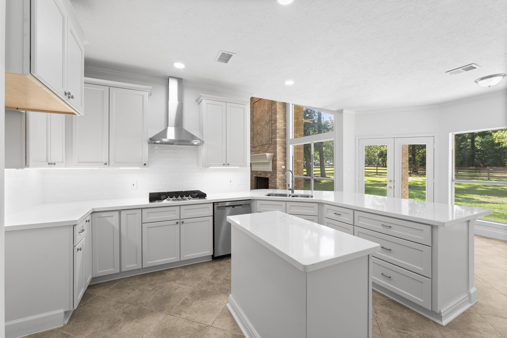 15456 Pin Oak Drive Conroe, TX 77384 - Photo 4 of 44 a kitchen with a sink stove and cabinets