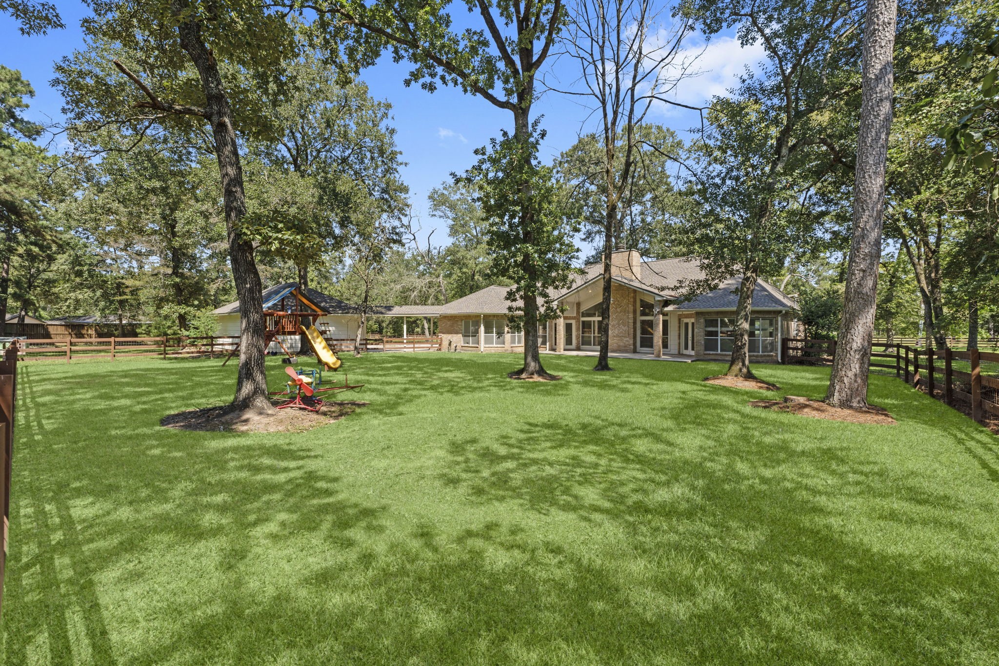 15456 Pin Oak Drive Conroe, TX 77384 - Photo 41 of 44 a view of a house with backyard and a tree