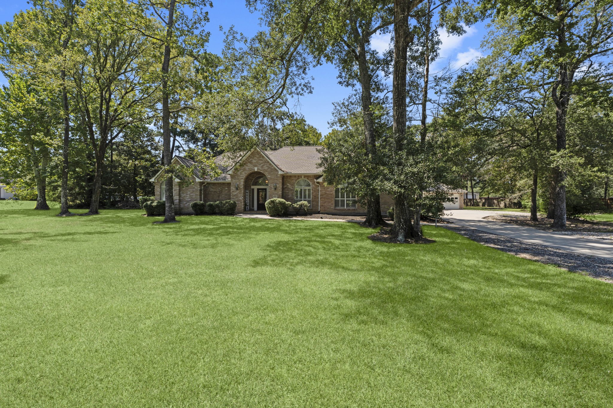 15456 Pin Oak Drive Conroe, TX 77384 - Photo 9 of 44 a view of house with garden and trees