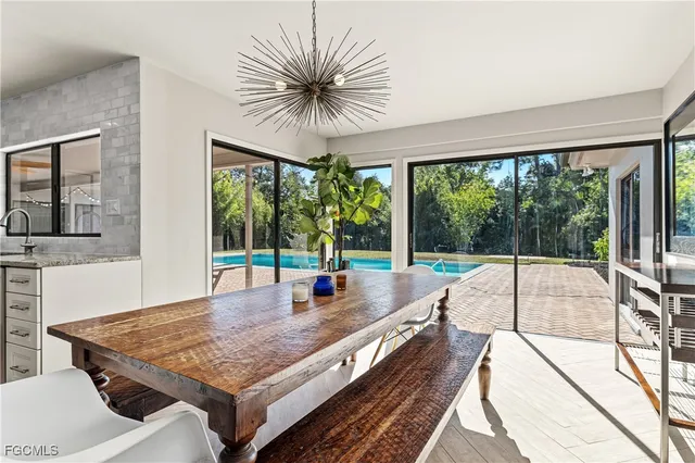 a living room with pool table and a large window