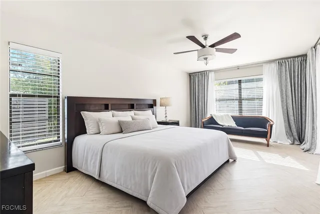 a bedroom with a bed and a large window