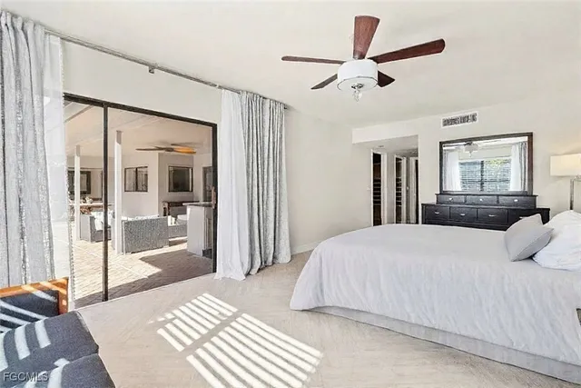 a bedroom with a large bed and a chandelier