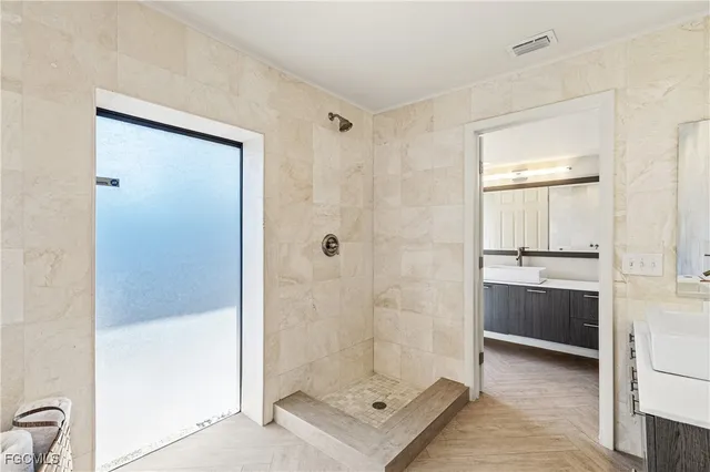 a bathroom with a shower and a sink