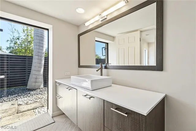 a kitchen with a sink cabinets and a window