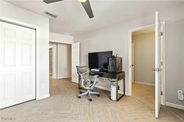 a view of a livingroom with workspace and a window