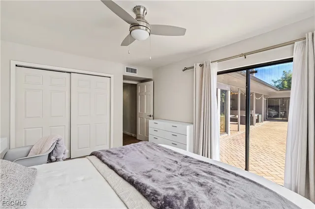 a bedroom with a large bed and a large window