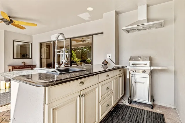 a kitchen with sink cabinets and stove
