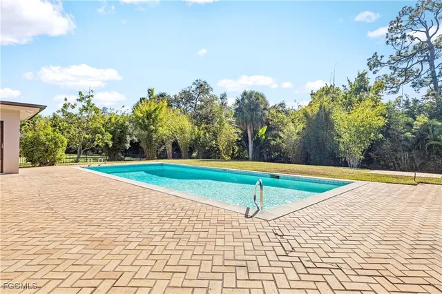 a view of a swimming pool with an outdoor space and seating area