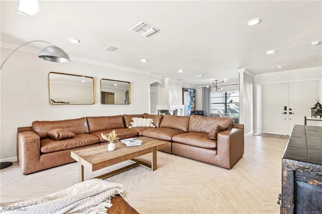 a living room with furniture and a glass door