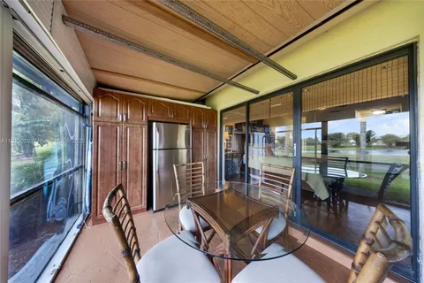 a balcony with furniture and a potted plant