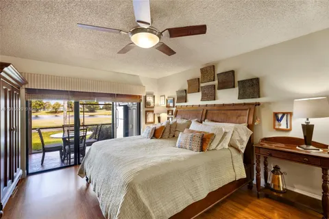 a bedroom with a balcony a bed and a chandelier