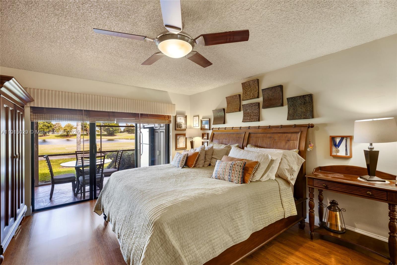 16175 Laurel Drive, Unit 27 Weston, FL 33326 - Photo 13 of 22 a bedroom with a balcony a bed and a chandelier