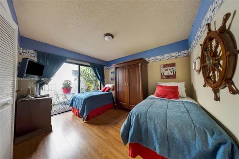 a bed room with a bed furniture and a flat screen tv