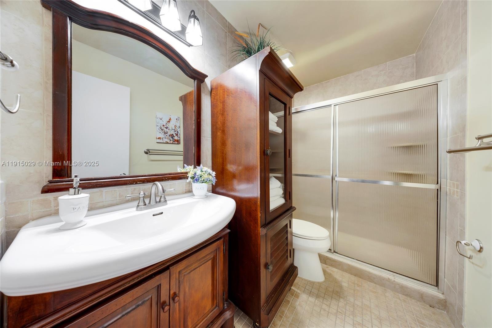 16175 Laurel Drive, Unit 27 Weston, FL 33326 - Photo 17 of 22 a bathroom with a sink and a mirror