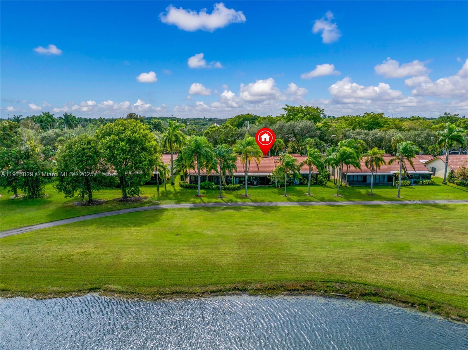 16175 Laurel Drive, Unit 27 Weston, FL 33326 - Photo 20 of 22 a front view of a house with a garden and trees