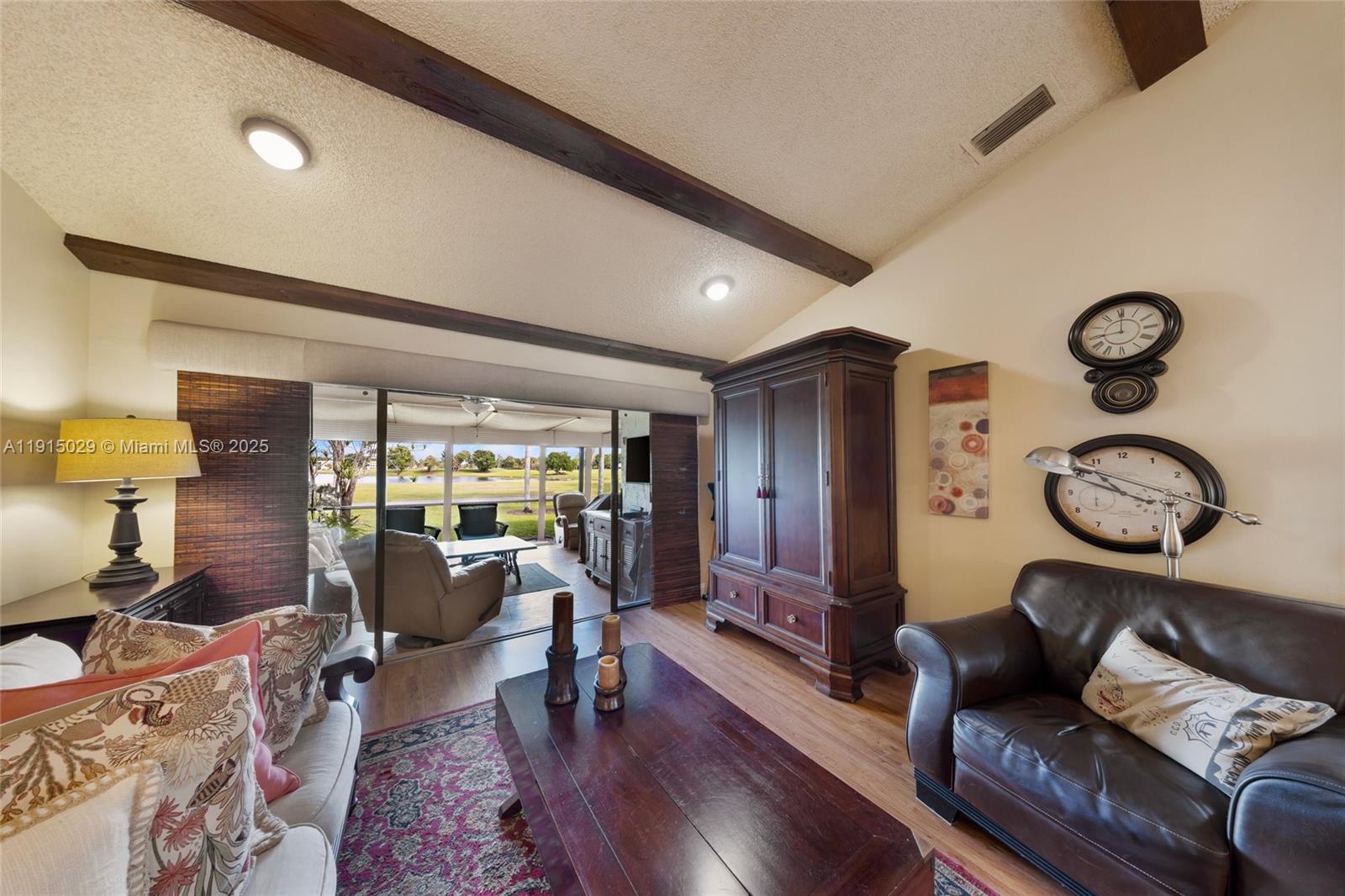 16175 Laurel Drive, Unit 27 Weston, FL 33326 - Photo 2 of 22 a living room with furniture and wooden floor
