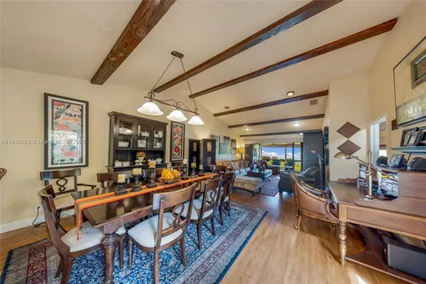 a outdoor space with lots of tables a large window and chairs