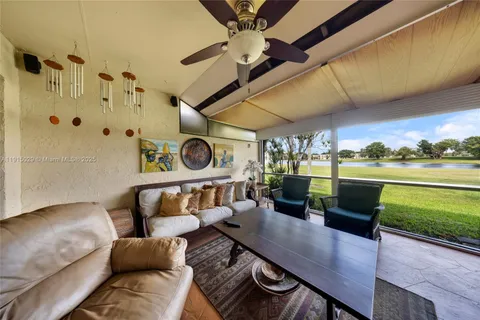 a living room with furniture and a floor to ceiling window
