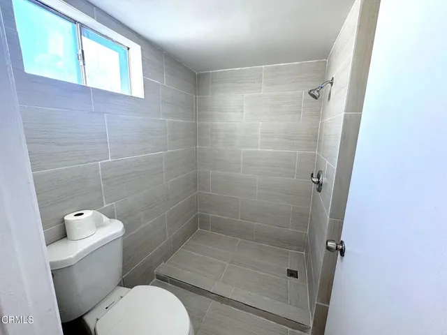 a bathroom with a toilet and a shower