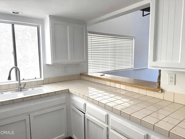 a kitchen with granite countertop a sink and a window