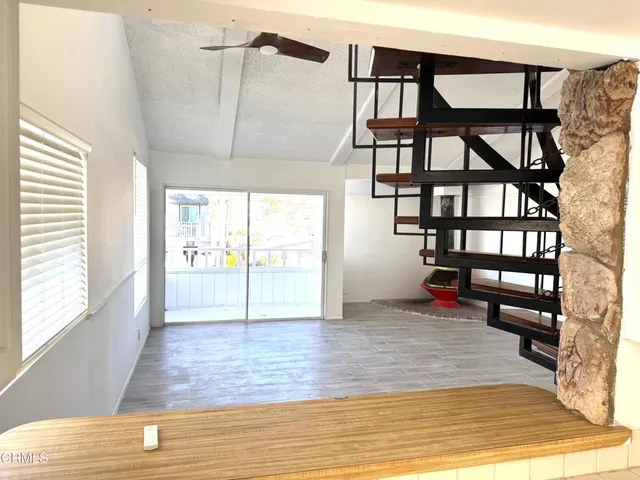 a view of a livingroom with wooden floor and a window