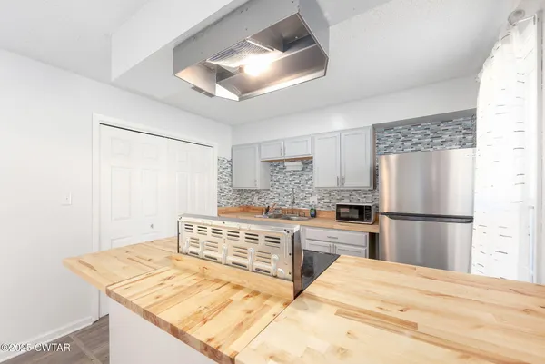 a kitchen with a refrigerator and a stove