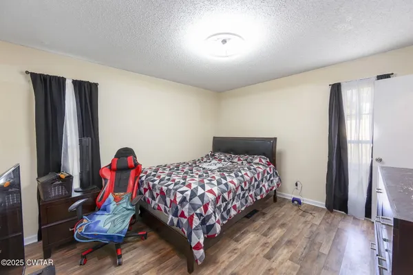 a bedroom with bed and a mirror