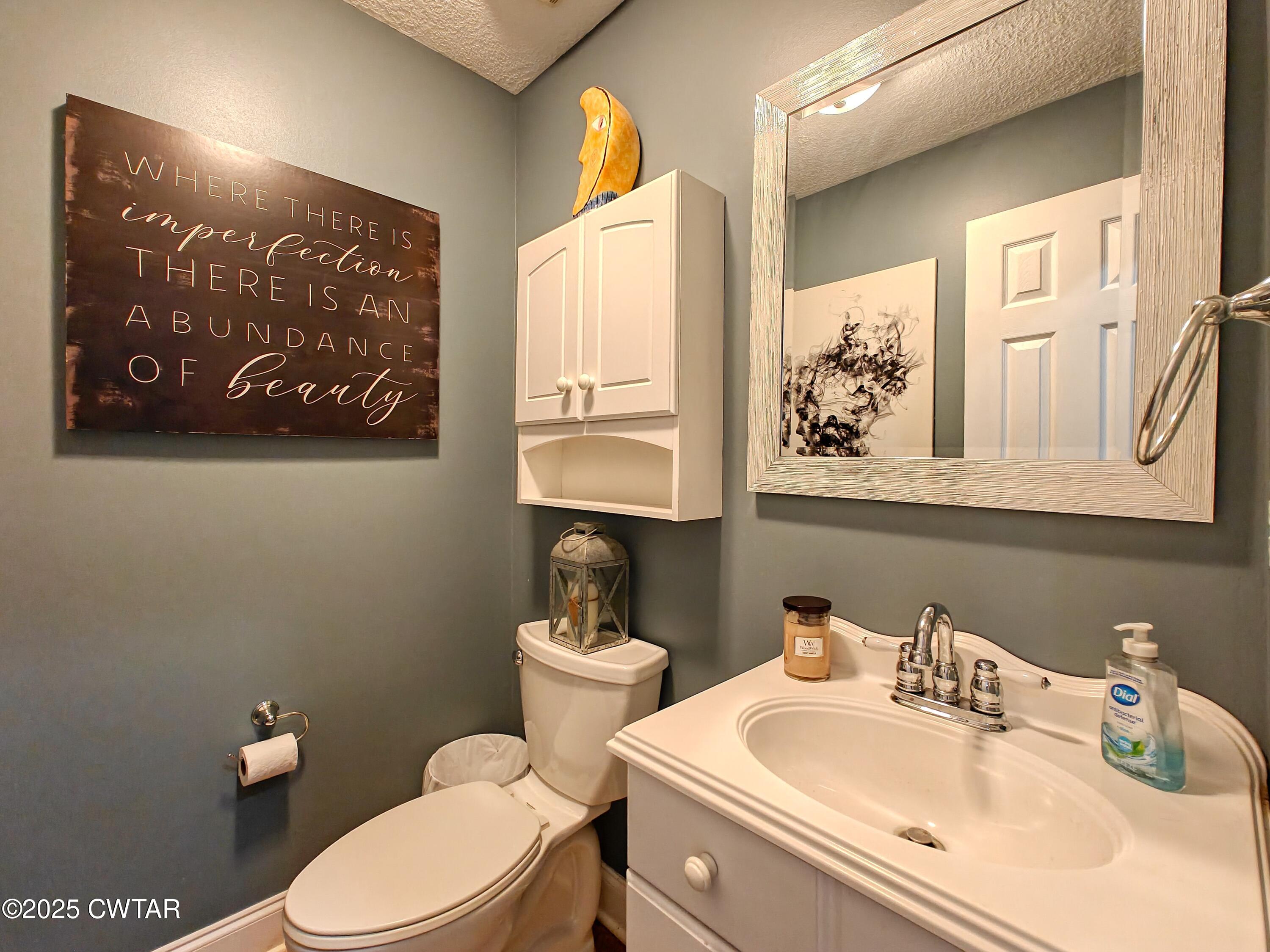 2345 East Grove Road Gleason, TN 38229 - Photo 11 of 44 a bathroom with a toilet sink and mirror