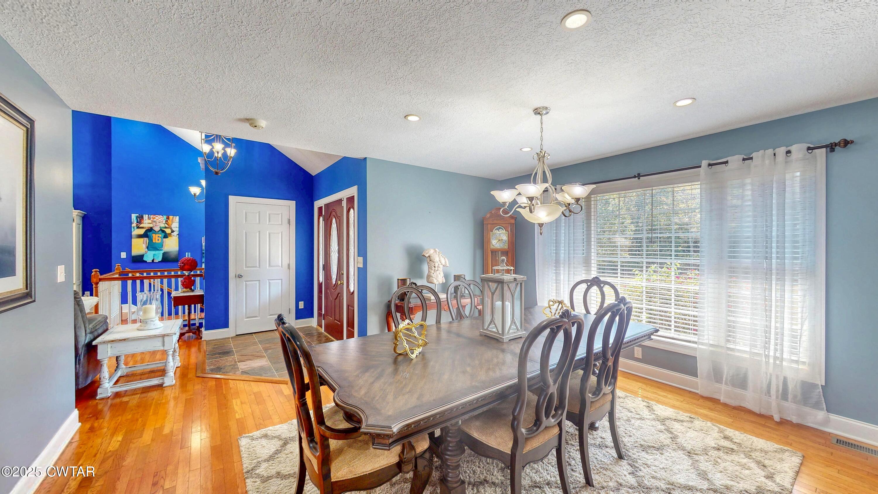 2345 East Grove Road Gleason, TN 38229 - Photo 13 of 44 a dining room with furniture a chandelier and wooden floor