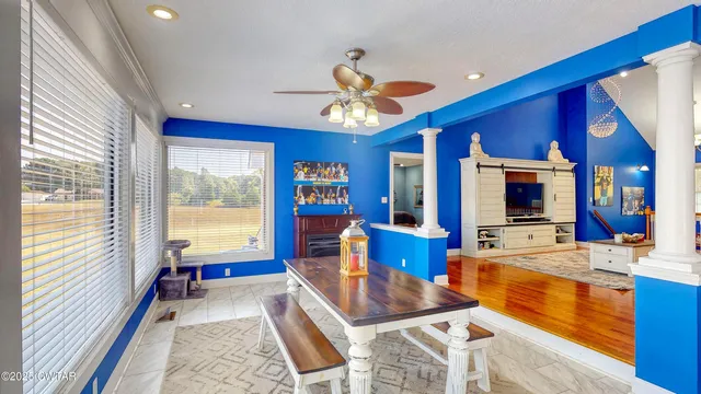 a room with pool table and large windows