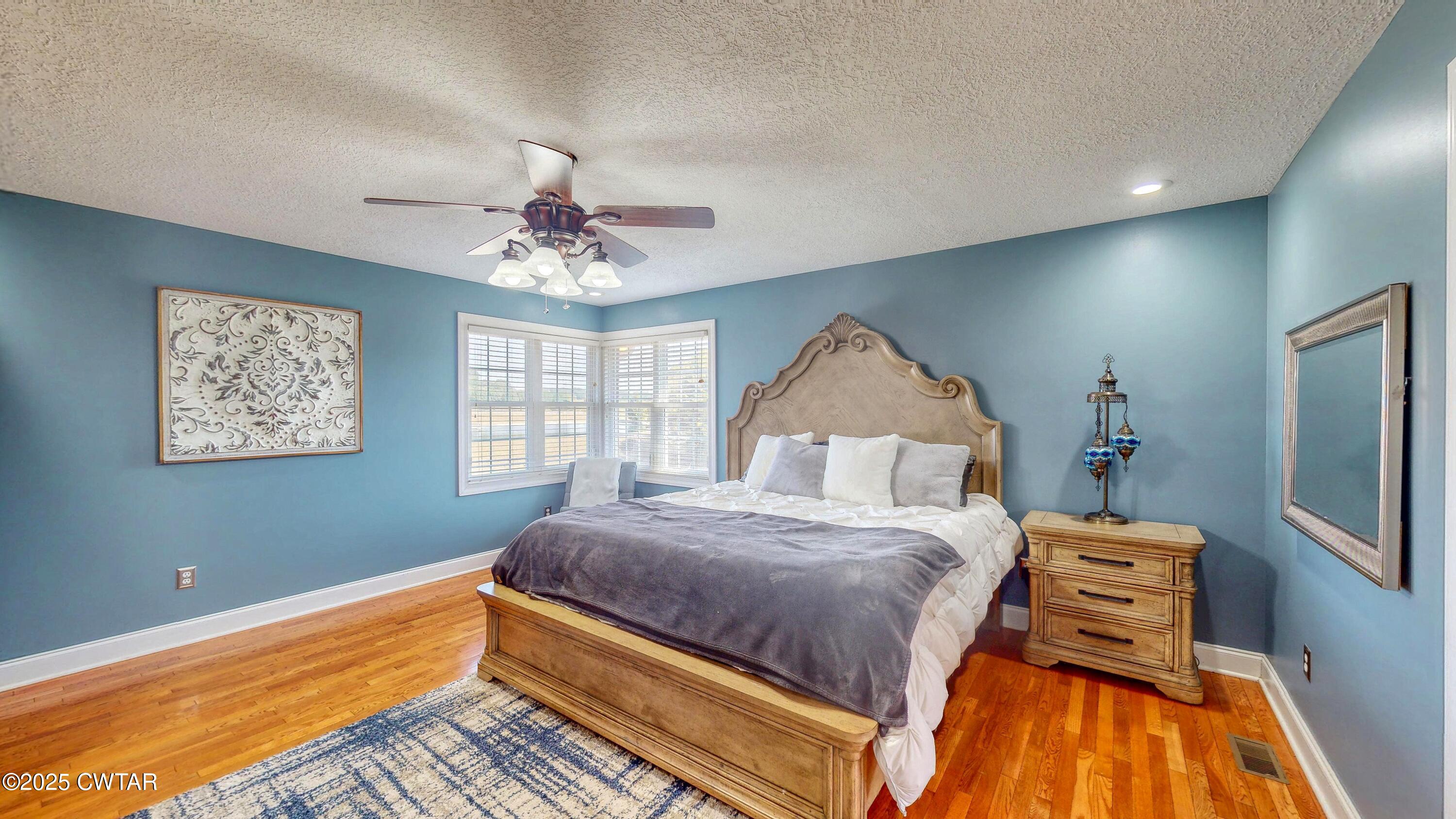 2345 East Grove Road Gleason, TN 38229 - Photo 16 of 44 a bedroom with a bed and a chandelier