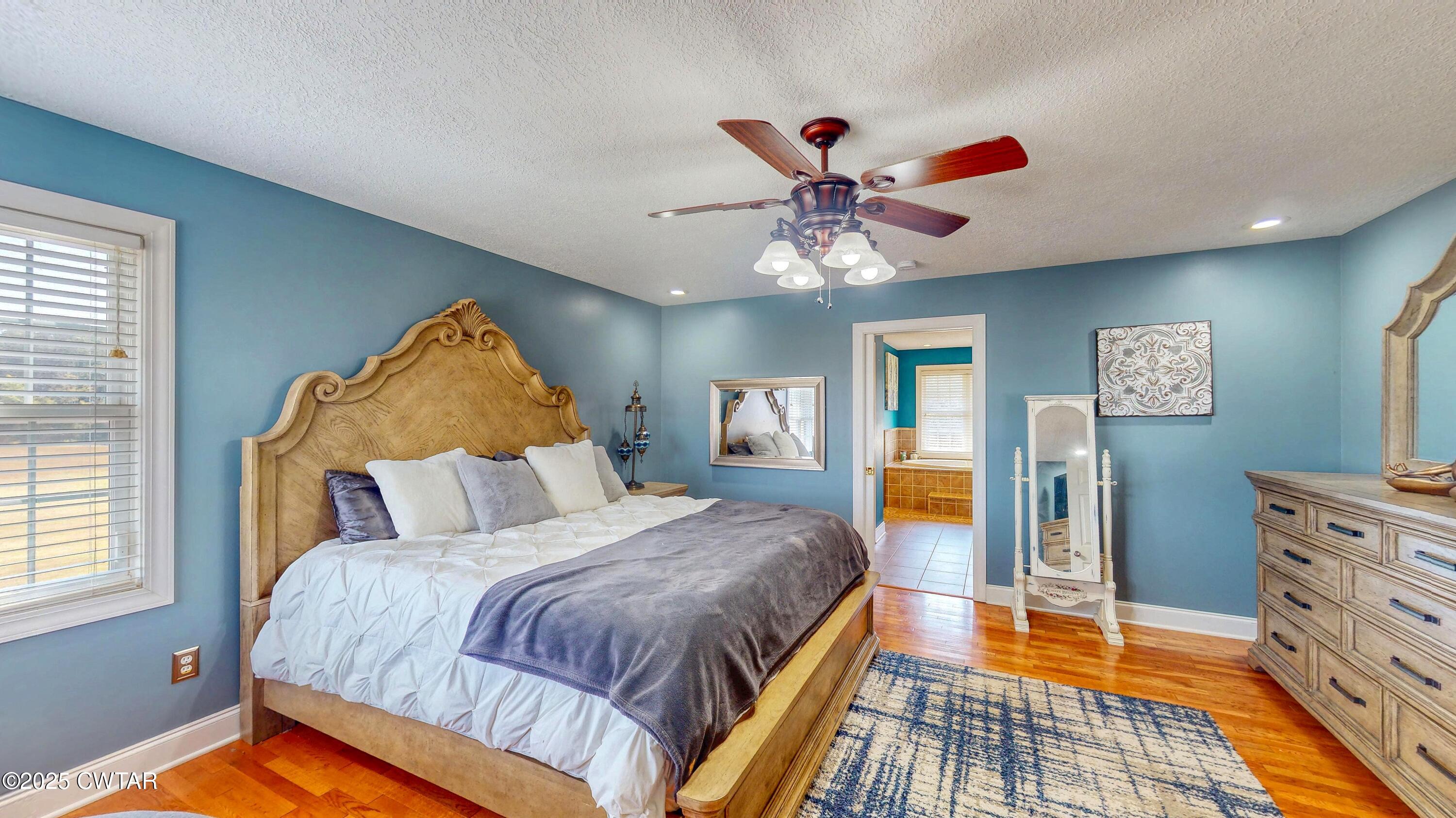 2345 East Grove Road Gleason, TN 38229 - Photo 17 of 44 a bedroom with a bed and a chandelier