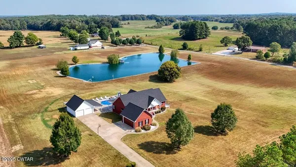 an aerial view of a house with a yard basket ball court and outdoor seating