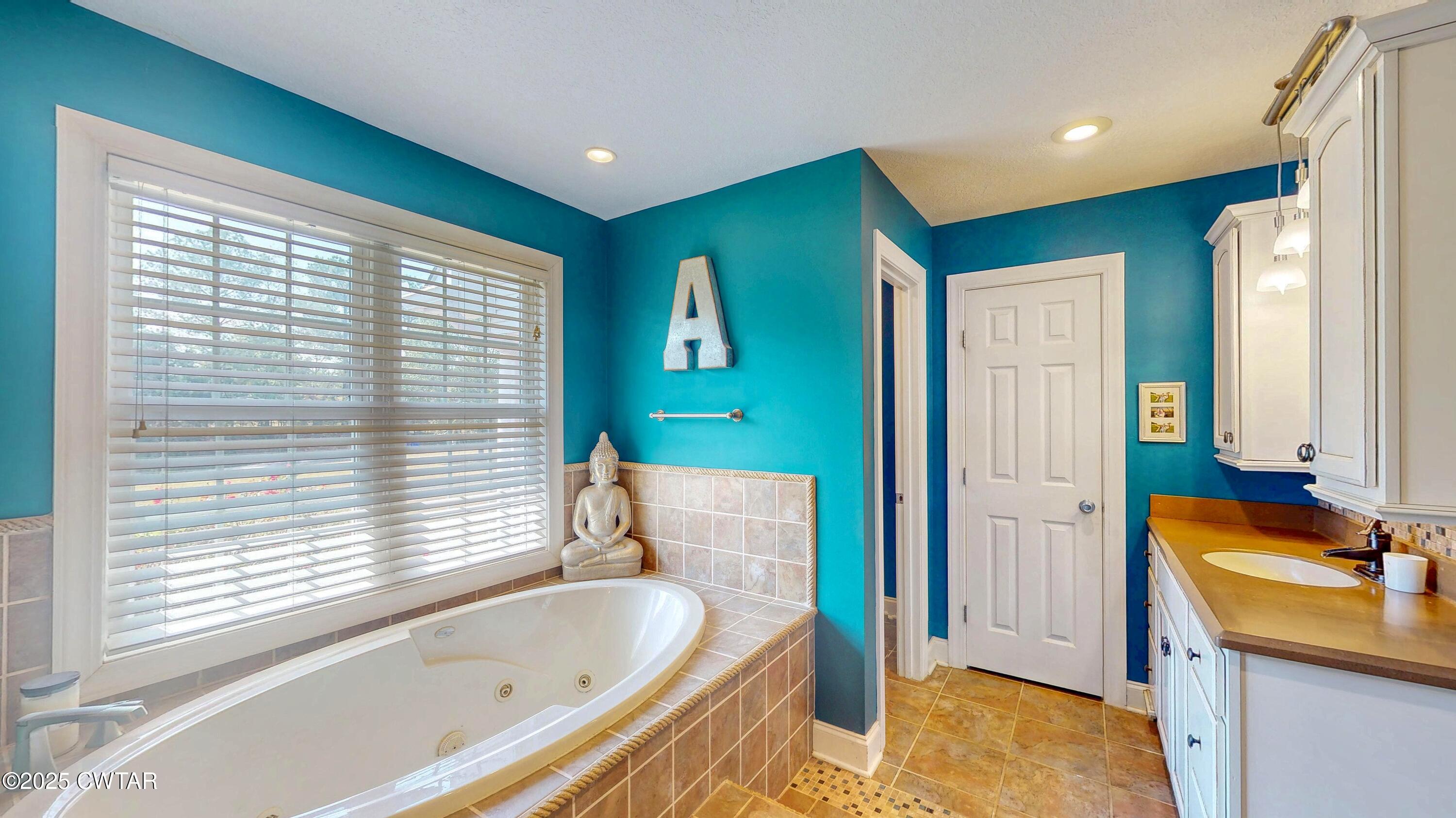 2345 East Grove Road Gleason, TN 38229 - Photo 21 of 44 a bathroom with a tub sink and mirror