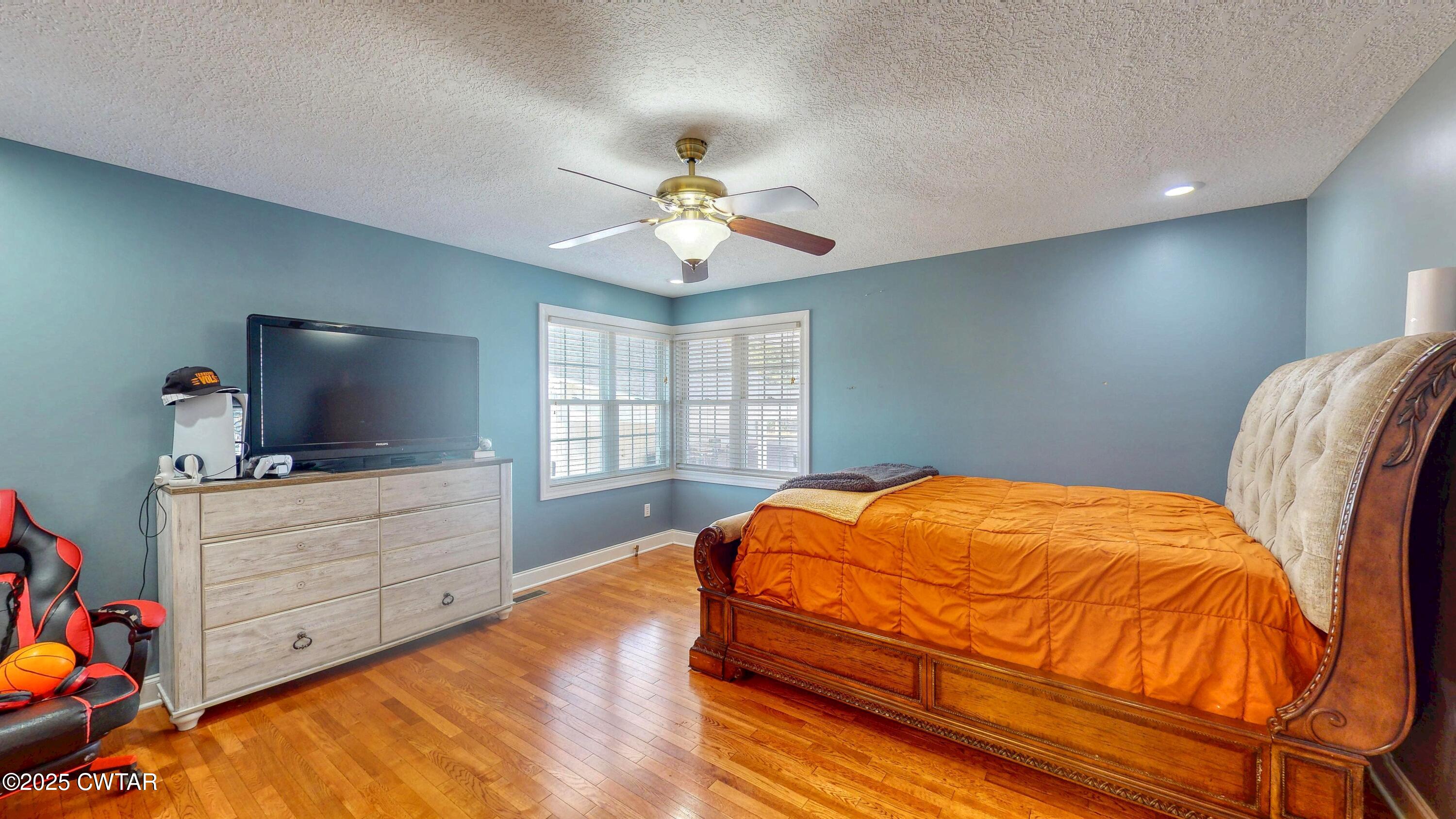 2345 East Grove Road Gleason, TN 38229 - Photo 22 of 44 a bedroom with a bed and a flat screen tv