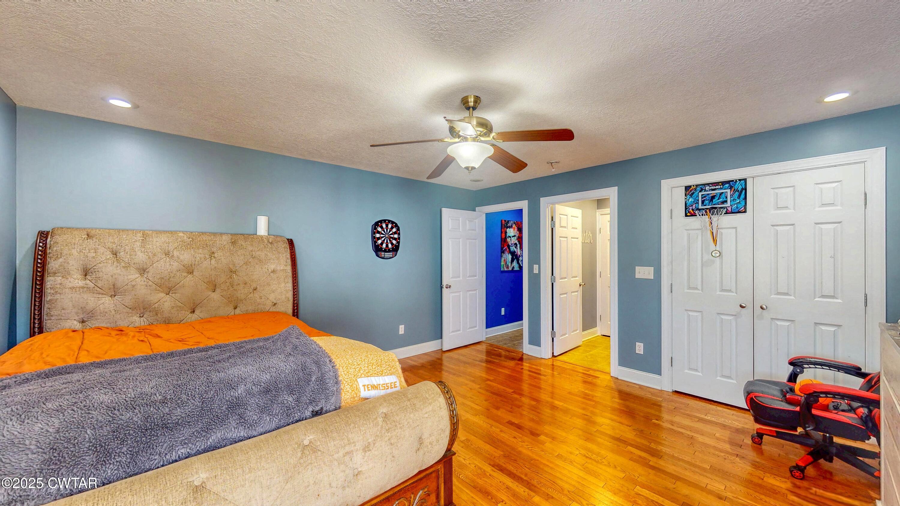 2345 East Grove Road Gleason, TN 38229 - Photo 23 of 44 a bedroom with a bed and a chandelier
