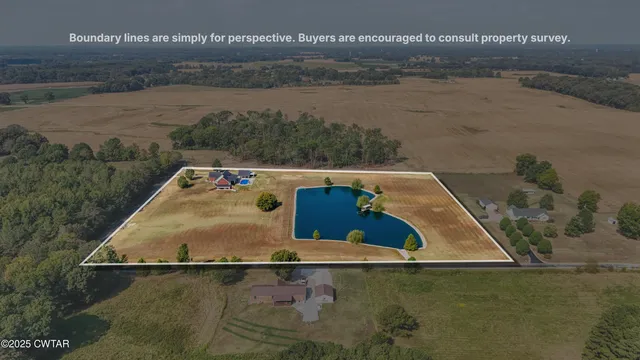 an aerial view of a house with a yard basket ball court and outdoor seating