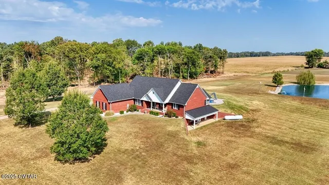 a living room with furniture a chandelier and a dining table