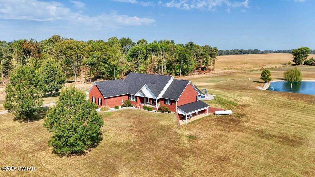 2345 East Grove Road Gleason, TN 38229 - Photo 6 of 44 a white house with a yard and lake view