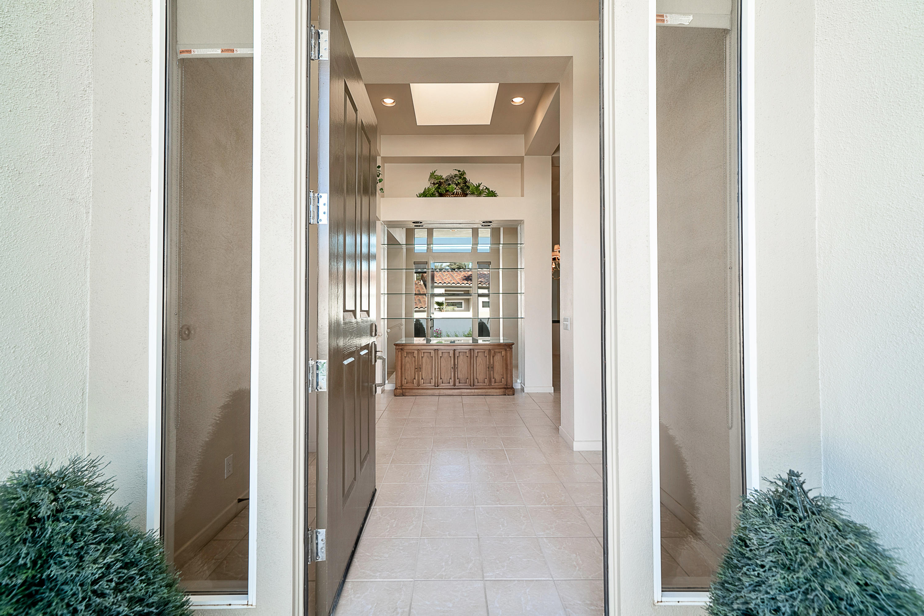 500 Red Arrow Trail Palm Desert, CA 92211 - Photo 14 of 60 a view of a hallway with wooden floor and a dining room