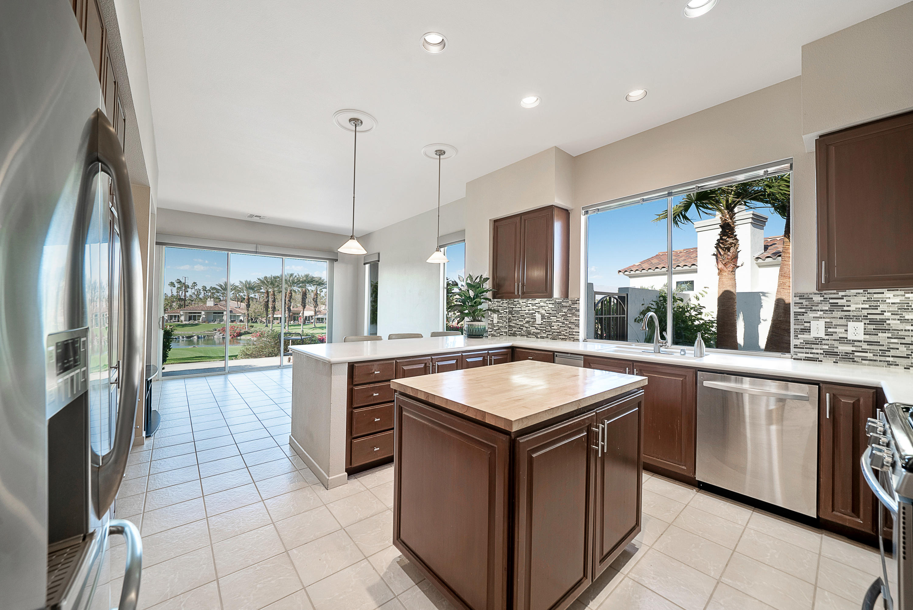 500 Red Arrow Trail Palm Desert, CA 92211 - Photo 16 of 60 a kitchen with stainless steel appliances granite countertop a sink and a stove