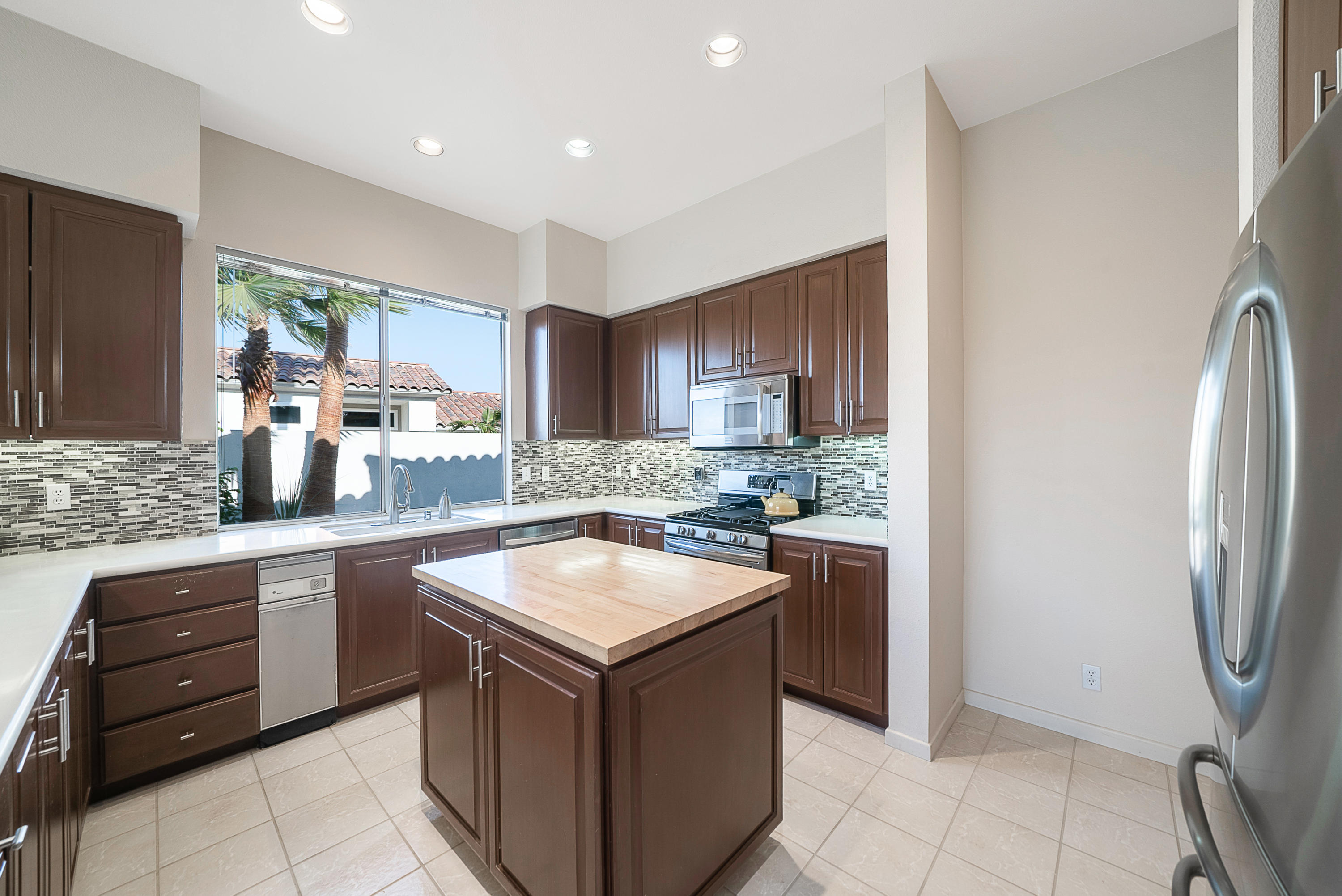 500 Red Arrow Trail Palm Desert, CA 92211 - Photo 19 of 60 a kitchen with a sink stove and refrigerator
