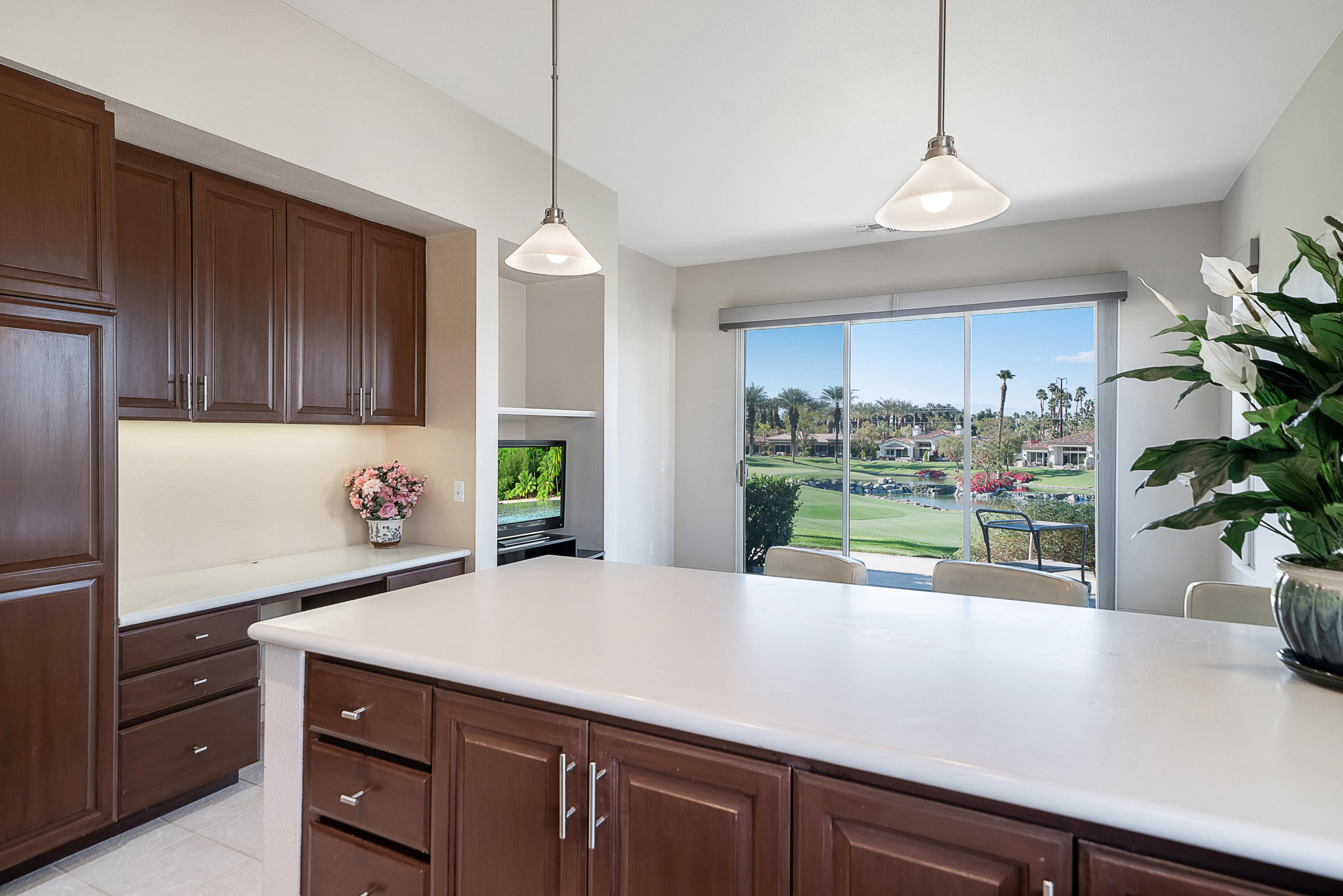 500 Red Arrow Trail Palm Desert, CA 92211 - Photo 20 of 60 a kitchen with a potted plant on the counter and cabinets