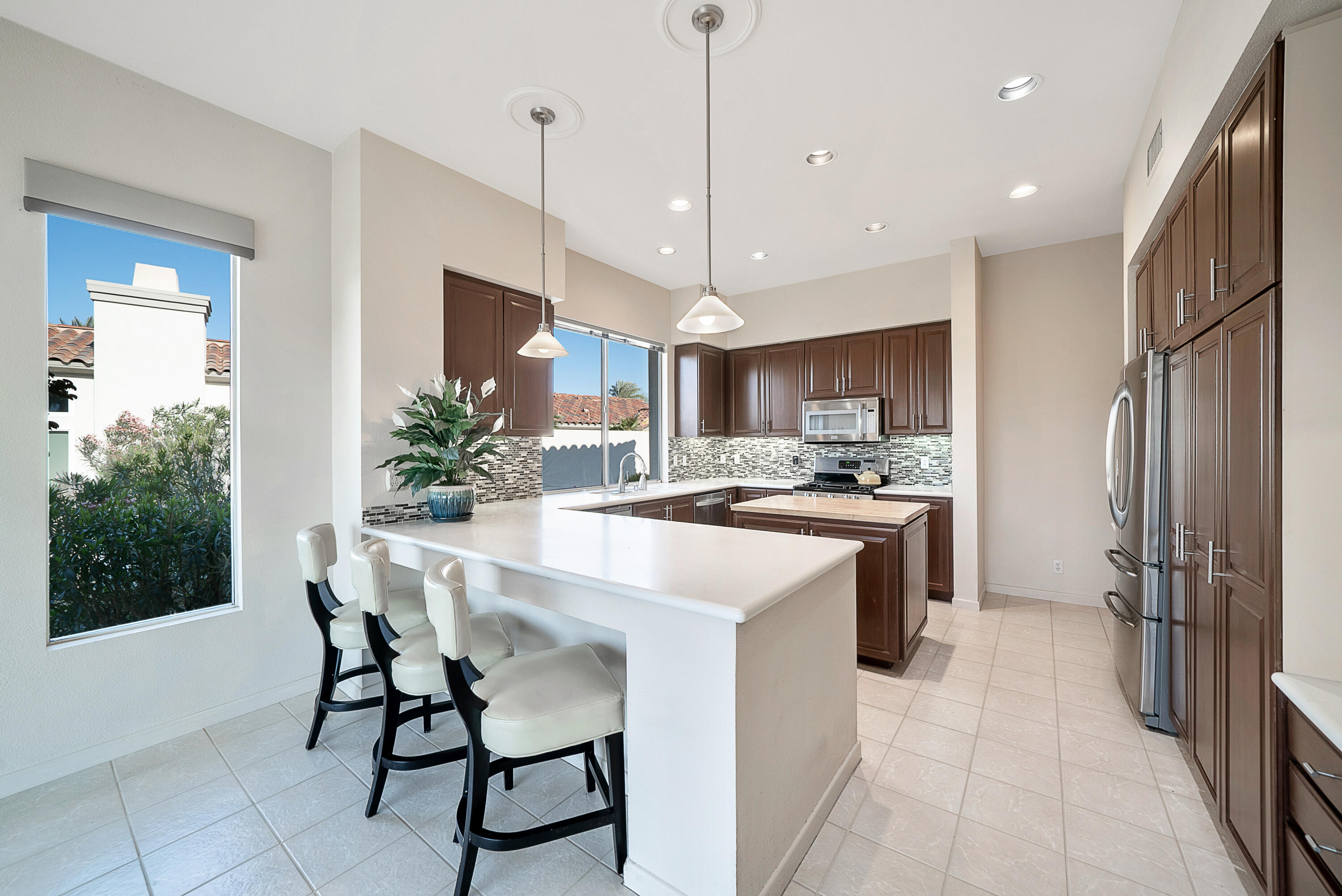 500 Red Arrow Trail Palm Desert, CA 92211 - Photo 22 of 60 a kitchen with kitchen island a counter top space appliances and a dining table