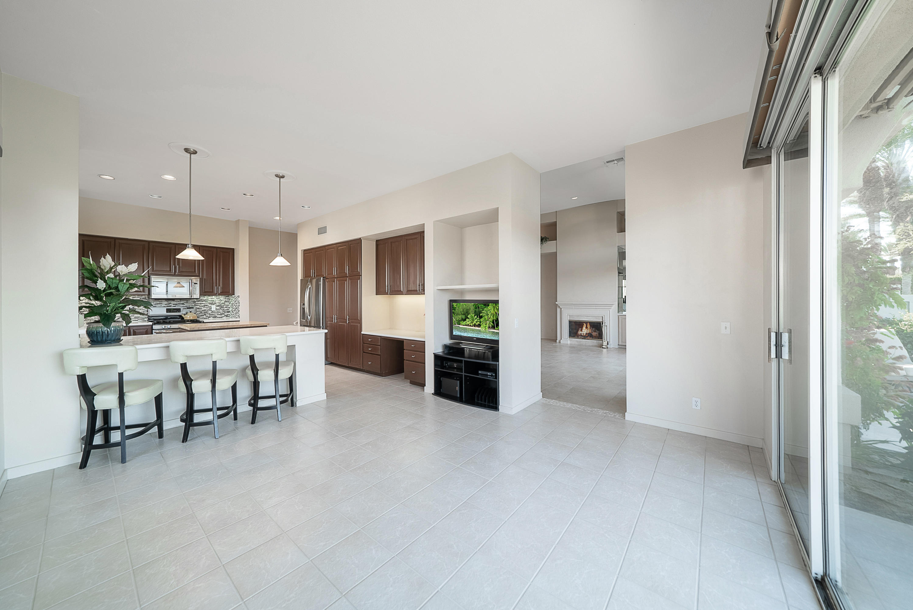 500 Red Arrow Trail Palm Desert, CA 92211 - Photo 24 of 60 a view of kitchen with kitchen island granite countertop a refrigerator and a dining table