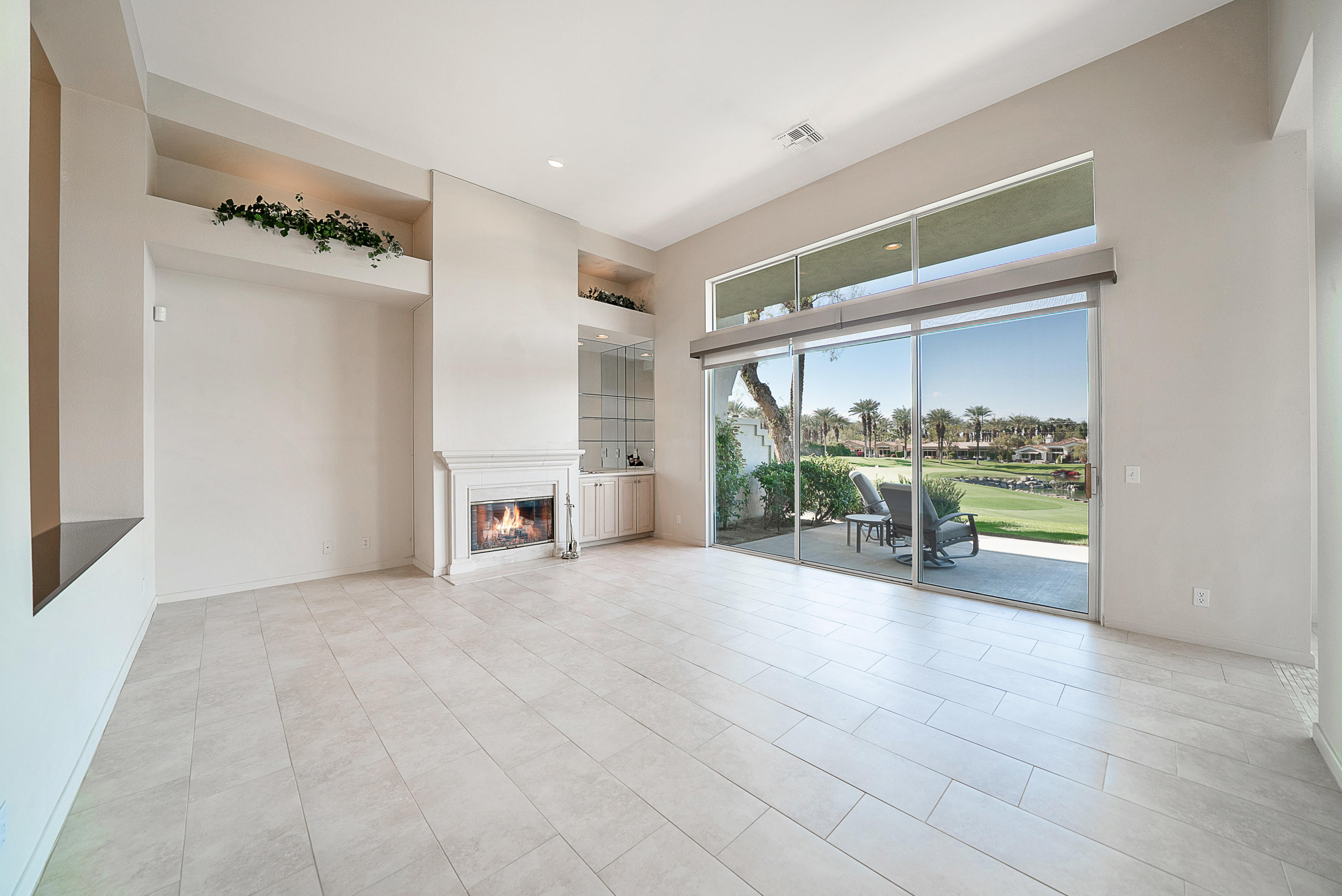 500 Red Arrow Trail Palm Desert, CA 92211 - Photo 27 of 60 a view of an empty room with a fireplace and a window
