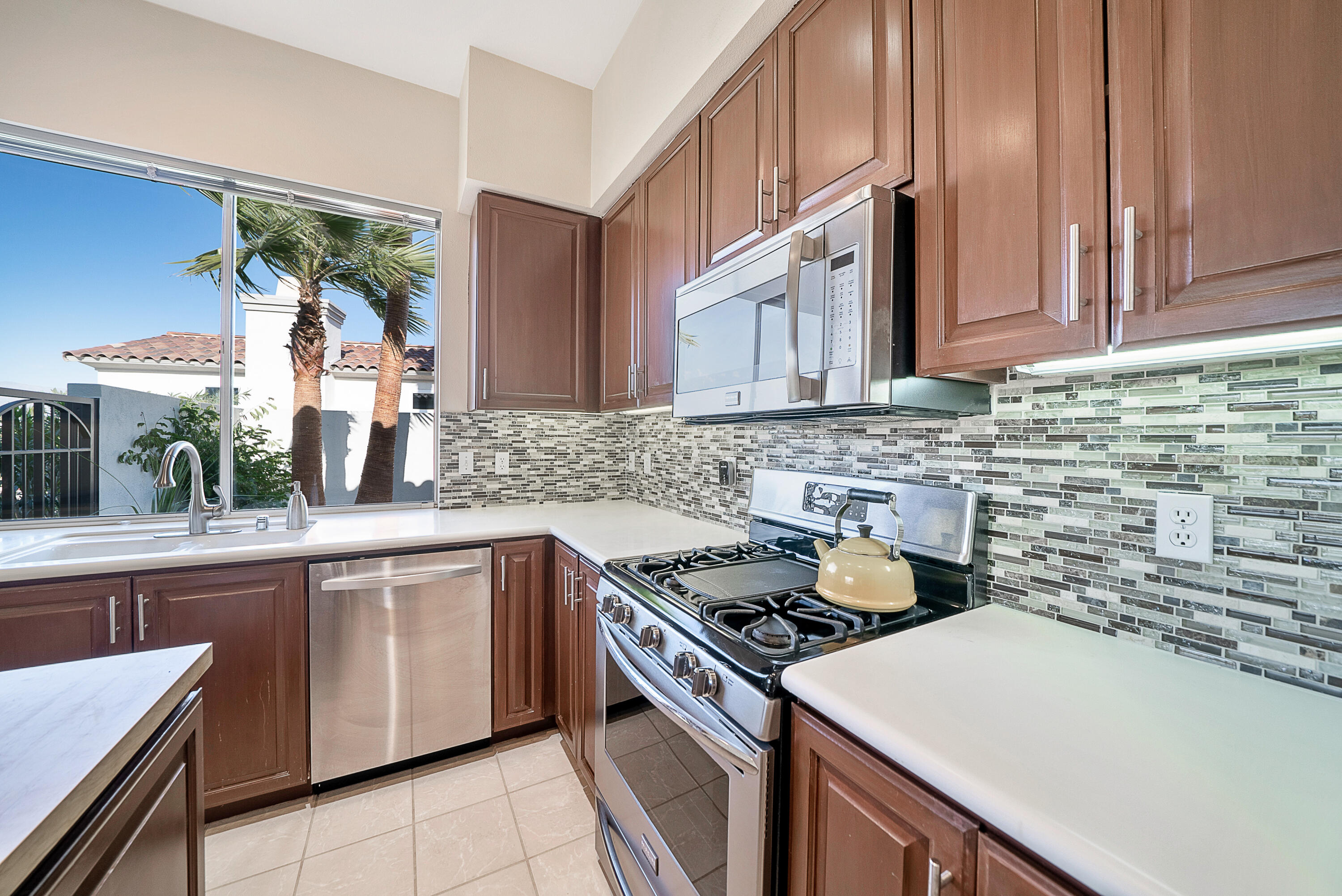 500 Red Arrow Trail Palm Desert, CA 92211 - Photo 4 of 60 a kitchen with a stove a sink and a refrigerator