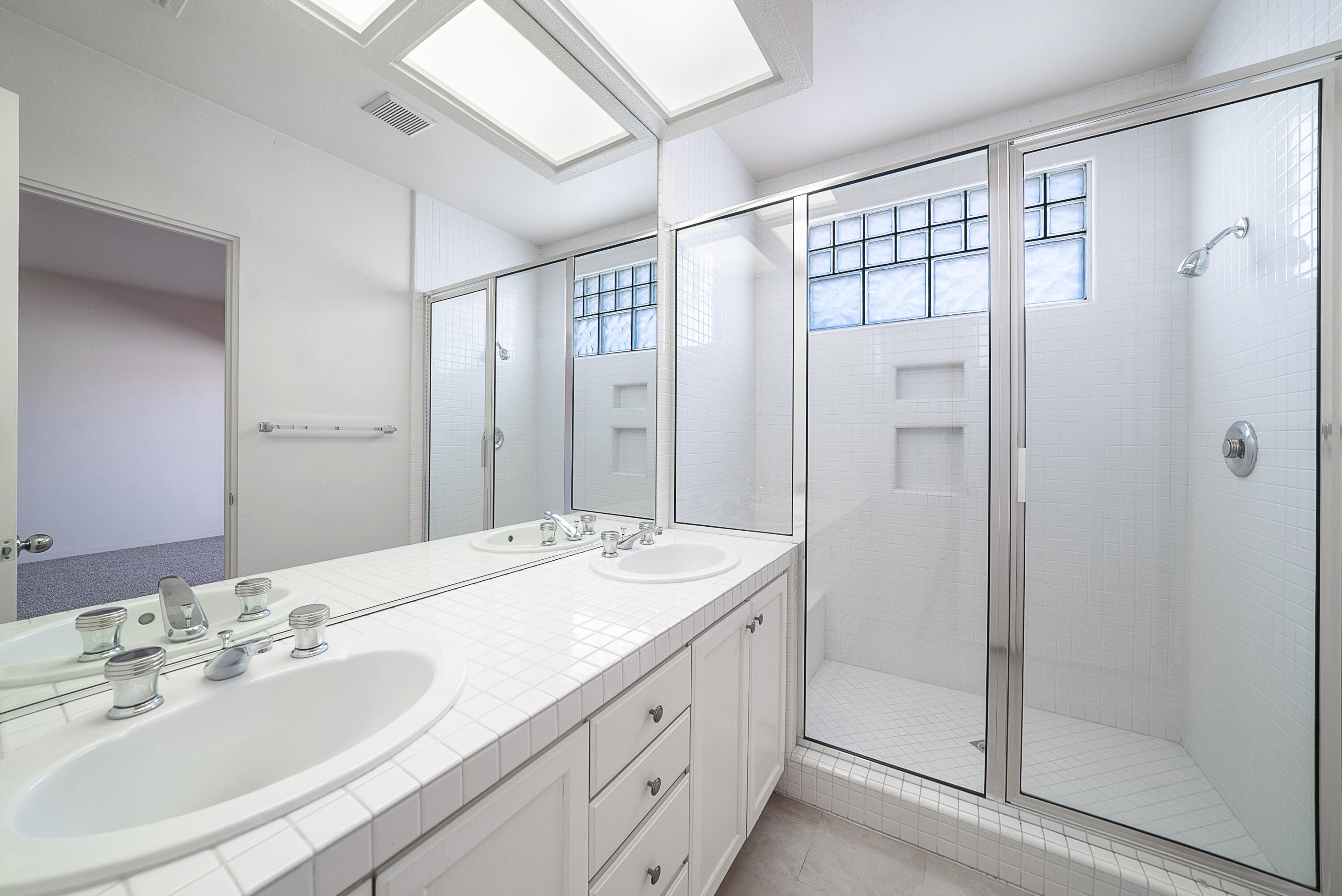500 Red Arrow Trail Palm Desert, CA 92211 - Photo 33 of 60 a bathroom with a double vanity sink mirror and shower