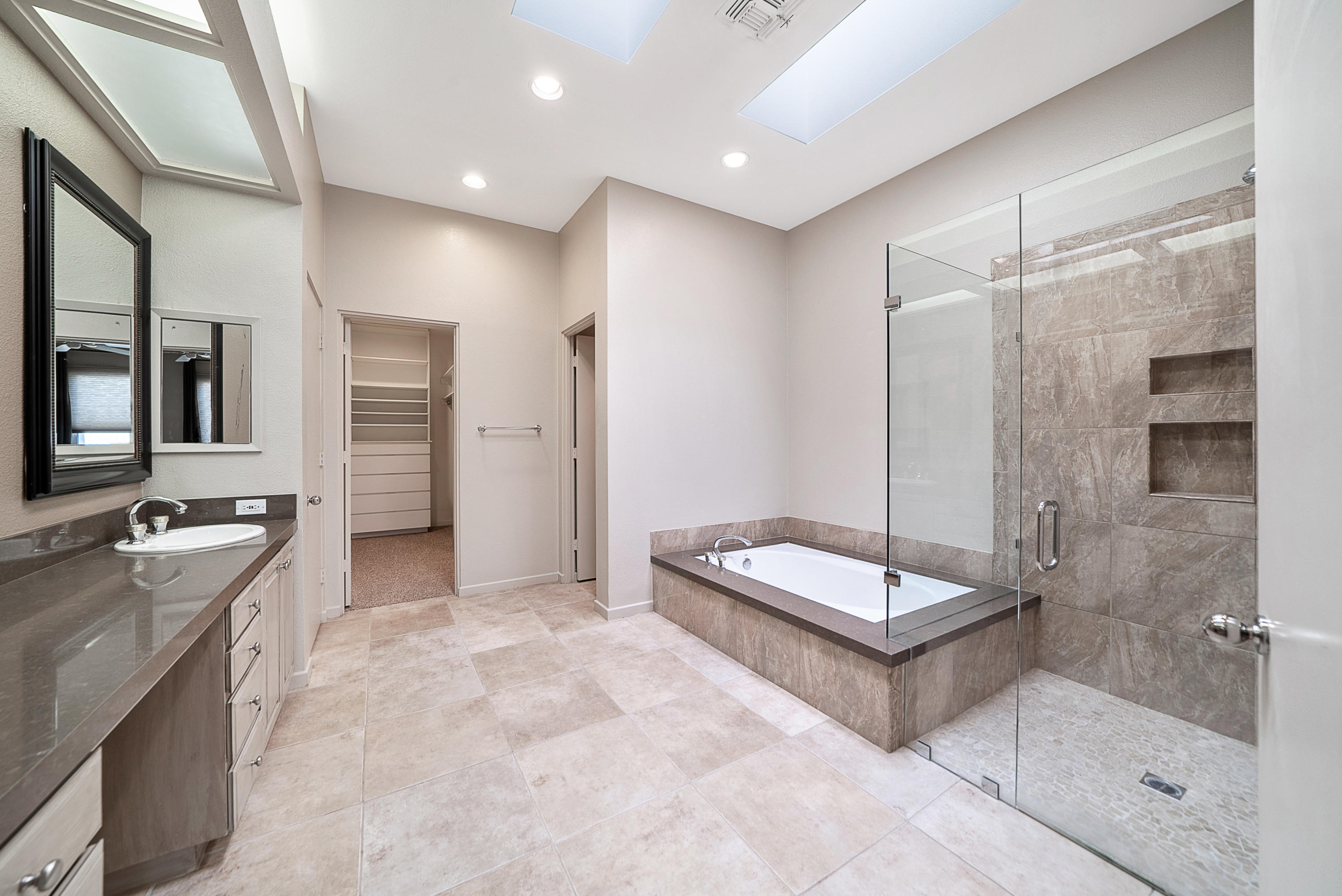 500 Red Arrow Trail Palm Desert, CA 92211 - Photo 36 of 60 a spacious bathroom with a tub shower and mirror