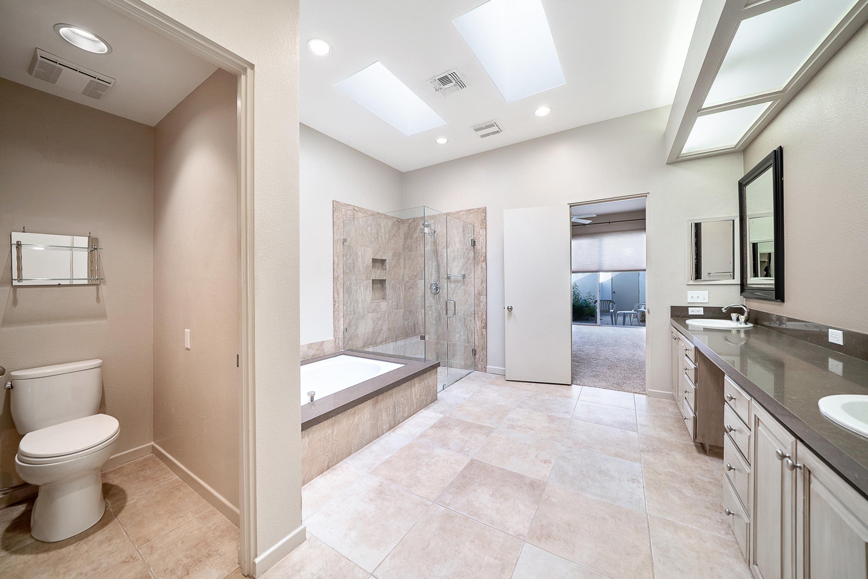 500 Red Arrow Trail Palm Desert, CA 92211 - Photo 37 of 60 a spacious bathroom with a granite countertop sink a toilet and shower